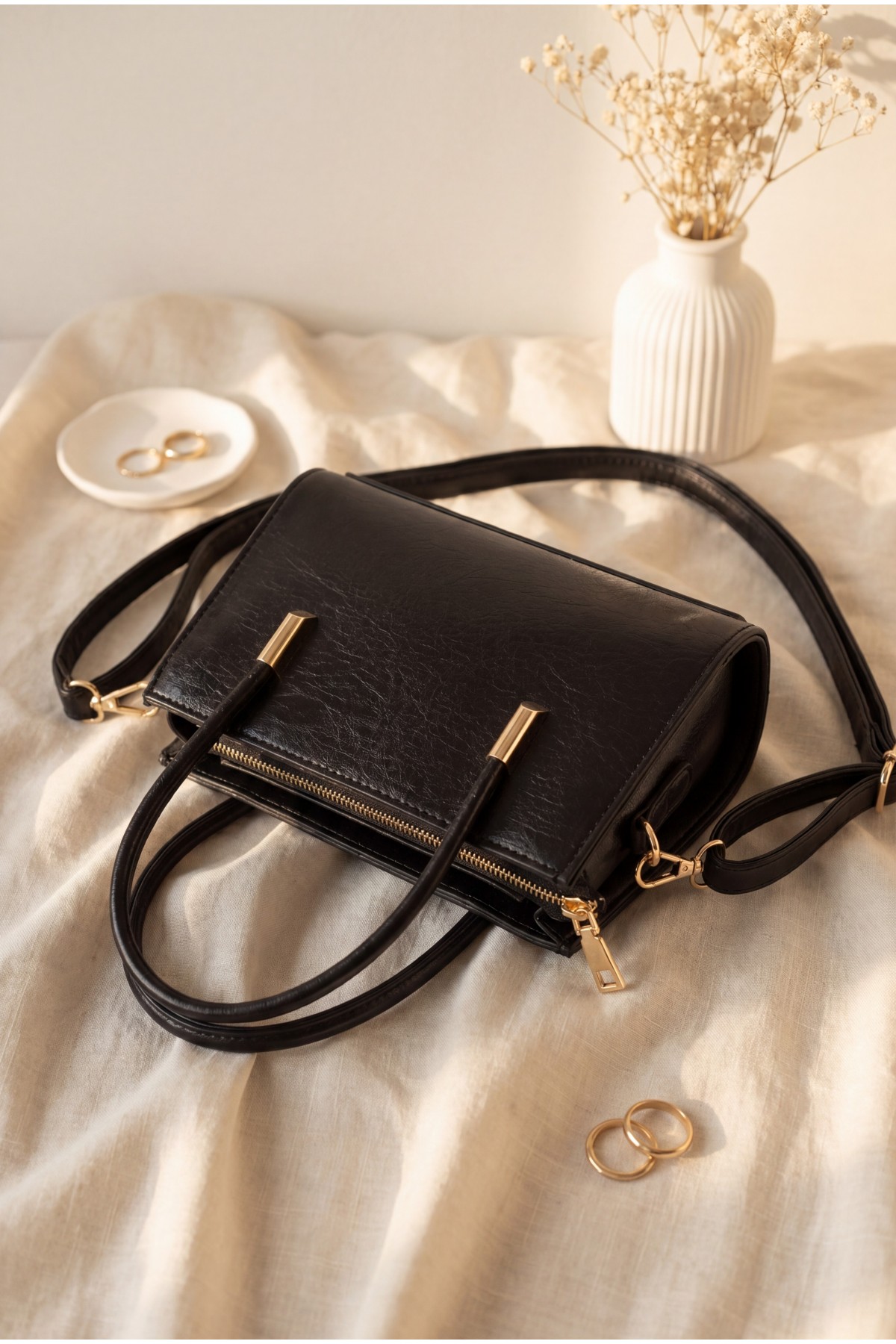 Long-strap patent leather bag with zipper closure and handles. -Black