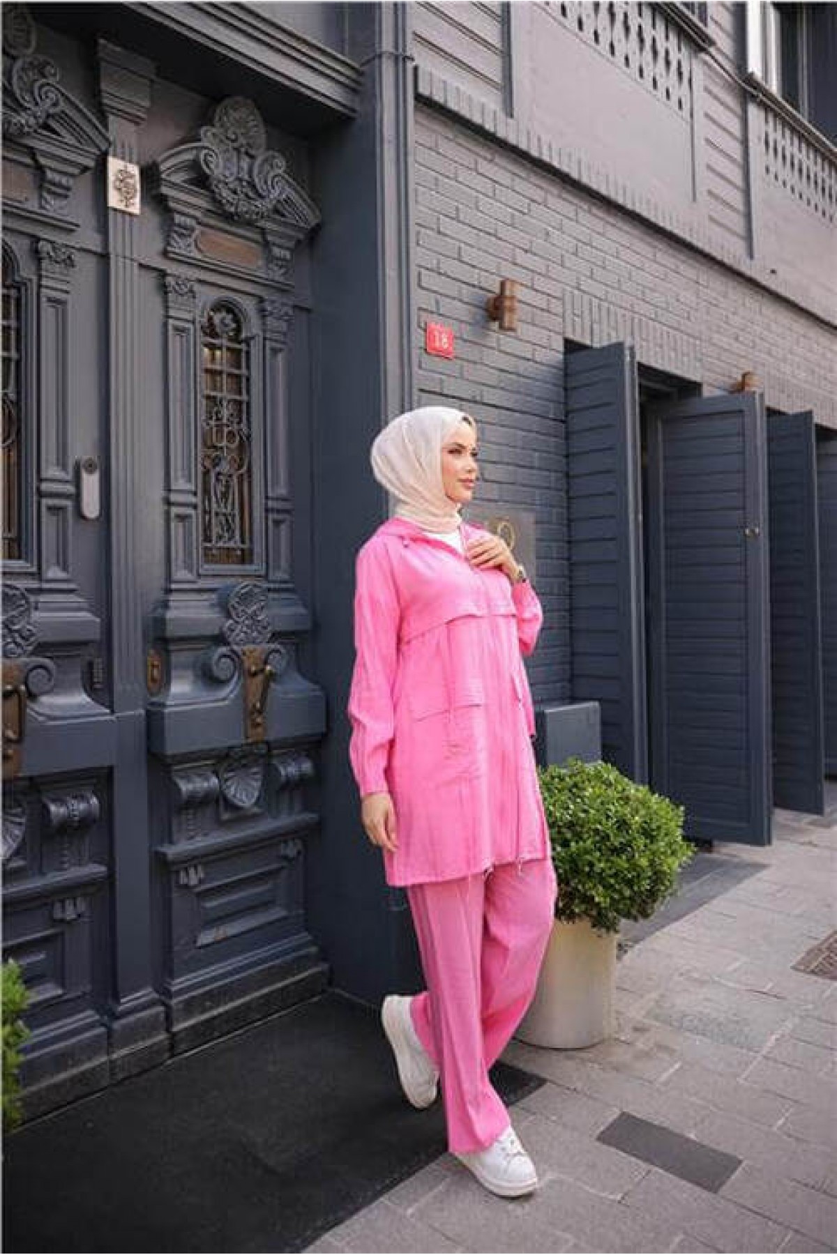 Short, two-piece modest tracksuit set with zipper, hood, and pockets.