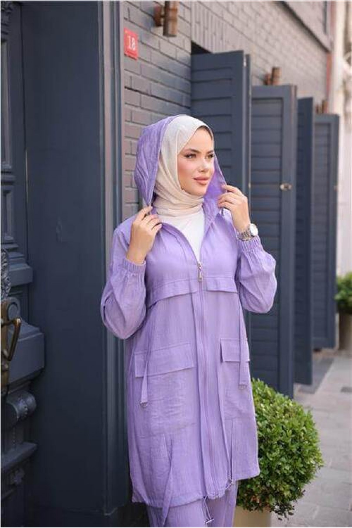 Short, two-piece modest tracksuit set with zipper, hood, and pockets.