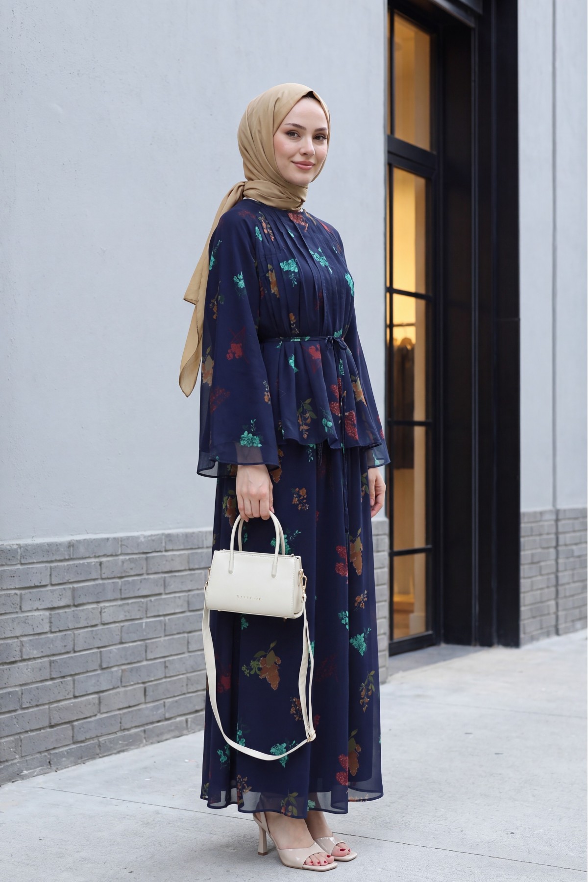 Spanish-style chiffon set with lined sleeves, belt, and floral skirt. -Navy blue