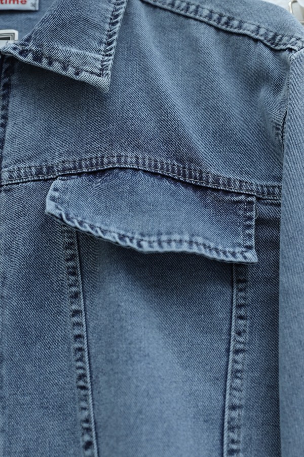 Denim suit with tassel detail, front zipper, and pocket detail. -Ice Blue