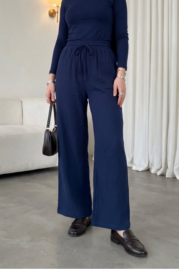 Wide-leg muslin trousers with elasticated waist and drawstring. -Navy blue