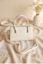 Long-strap patent leather bag with zipper closure and handles. -White