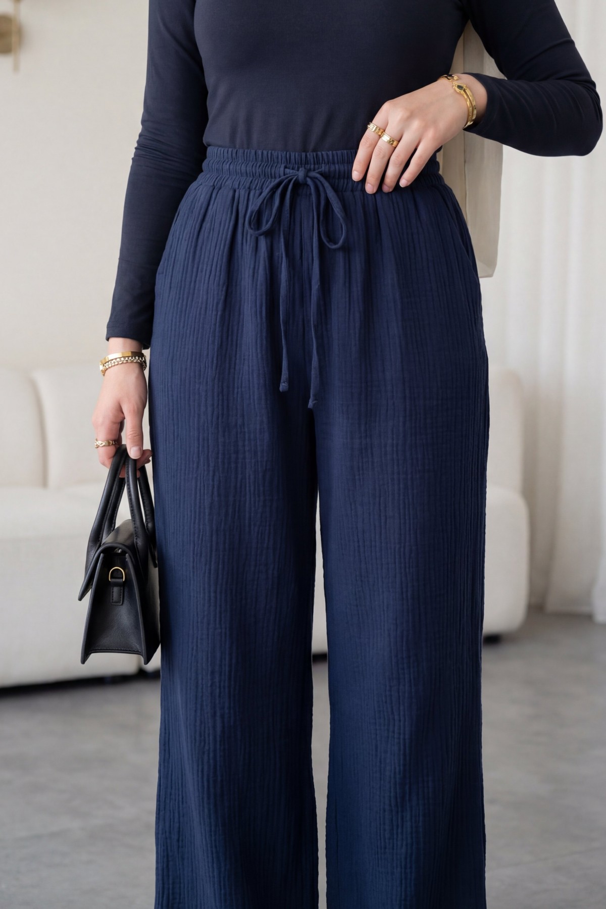 Wide-leg muslin trousers with elasticated waist and drawstring. -Navy blue