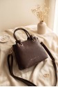 Multi-compartment shoulder bag with knot buckle and zipper and snap detail. -Dark Coffee
