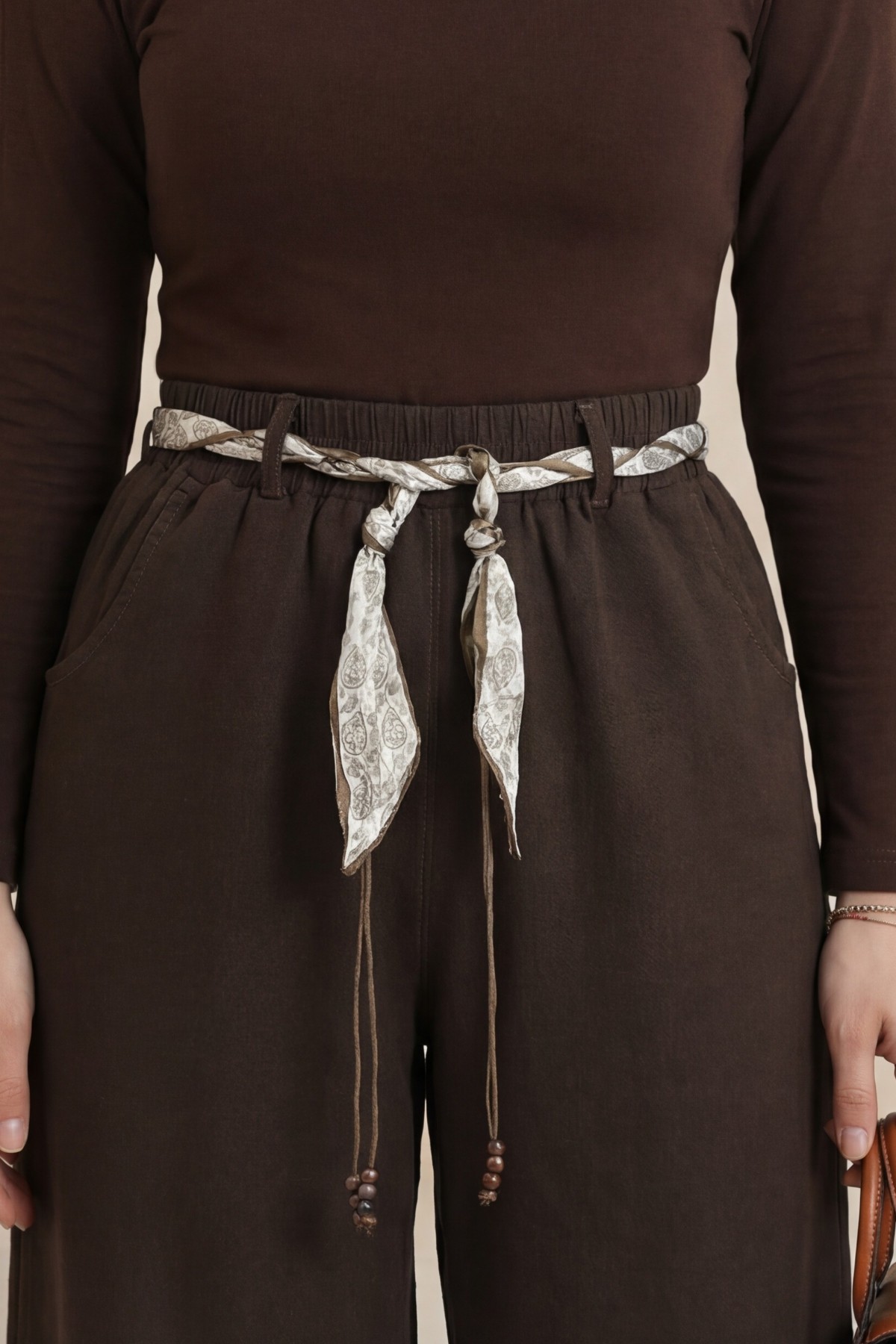 Wide-leg linen trousers with elasticated waist, belt, and pockets. -Brown