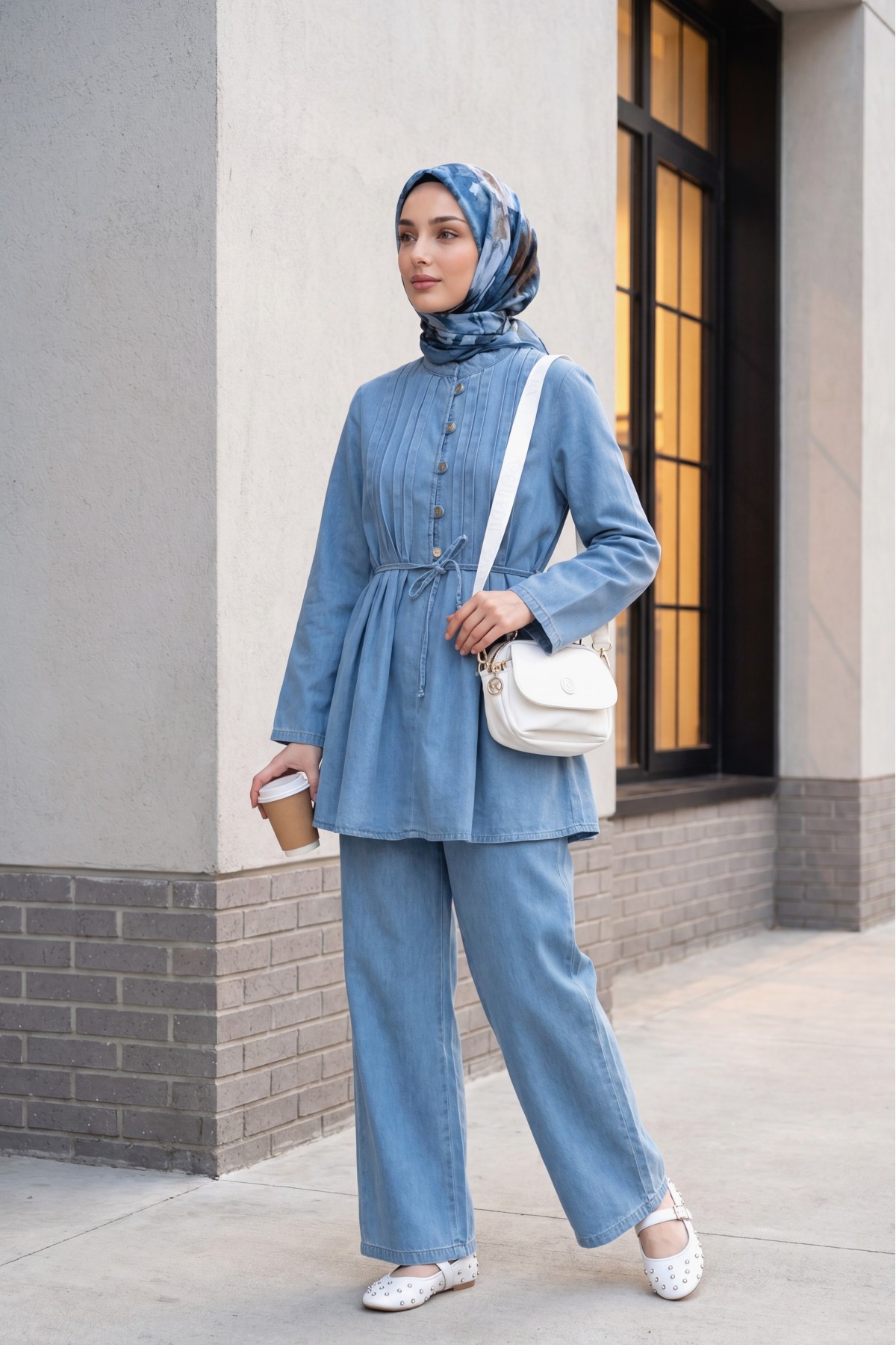 Half-buttoned, pleated front, tie-waist denim suit with trousers. -Light blue