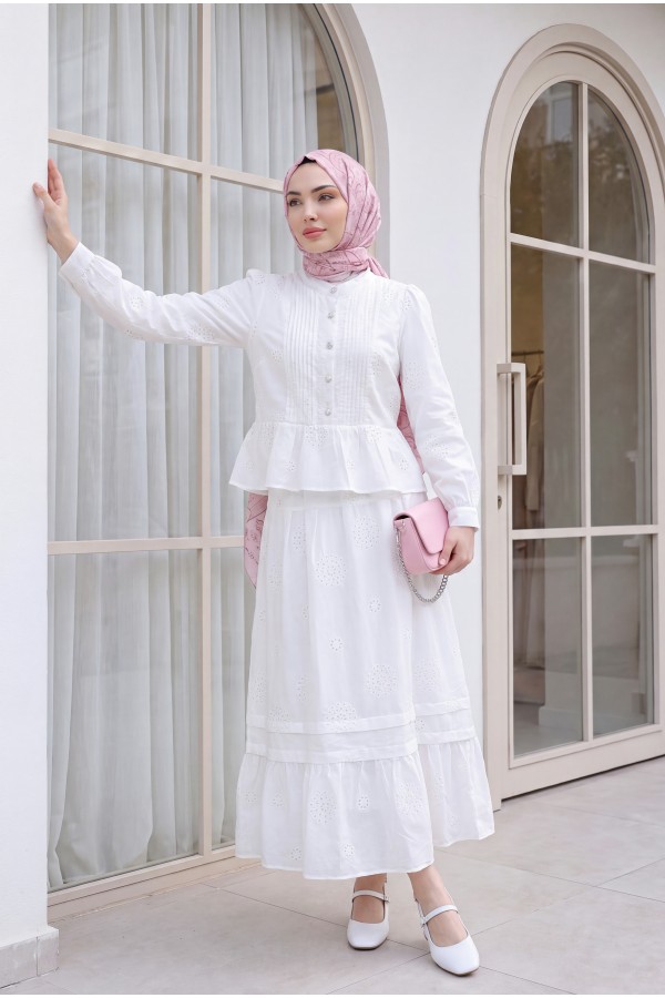 Linen suit with ribbed front, stone buttons, ruffled hem, and lined skirt. -White