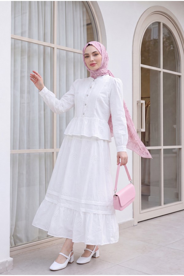 Linen suit with ribbed front, stone buttons, ruffled hem, and lined skirt. -White