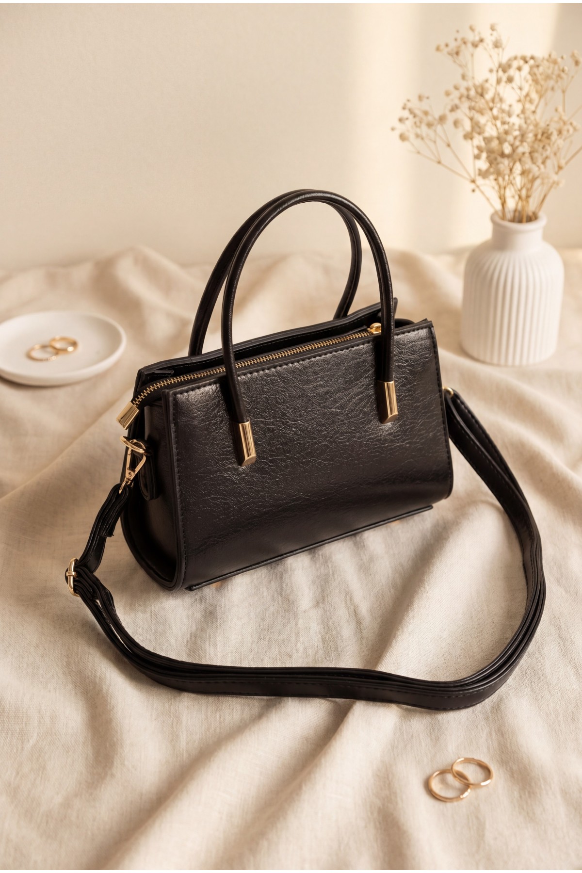 Long-strap patent leather bag with zipper closure and handles. -Black