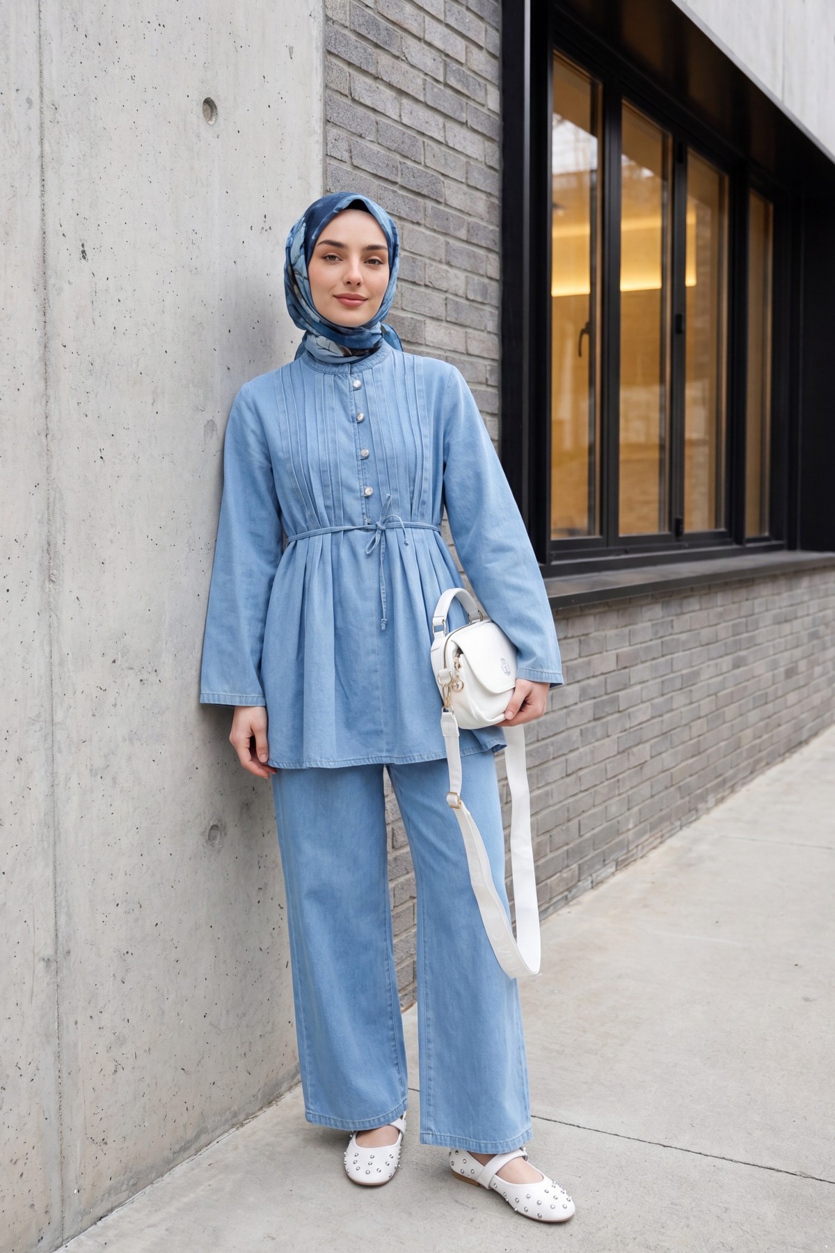 Half-buttoned, pleated front, tie-waist denim suit with trousers. -Light blue