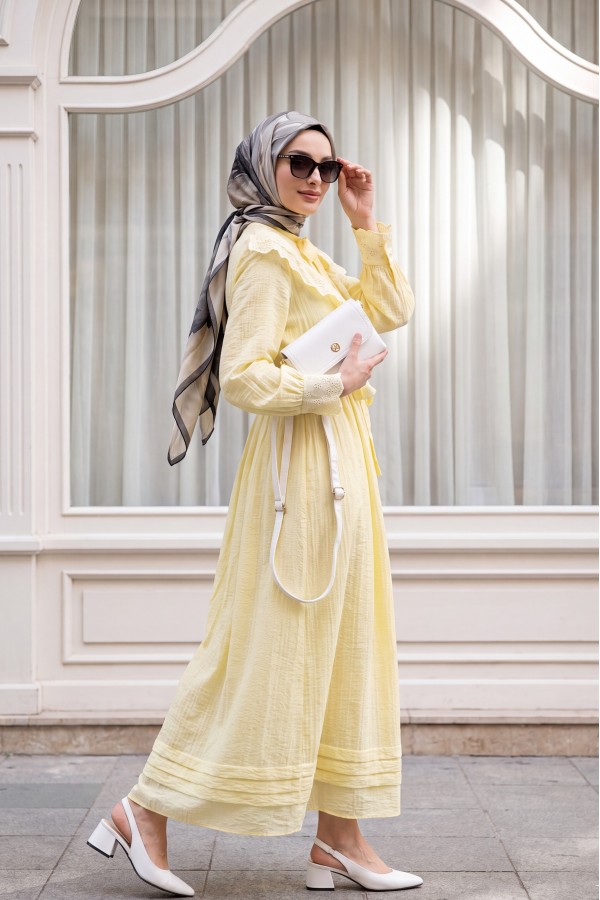Lined crinkle dress with lace detailing at the neckline and waist. -Yellow