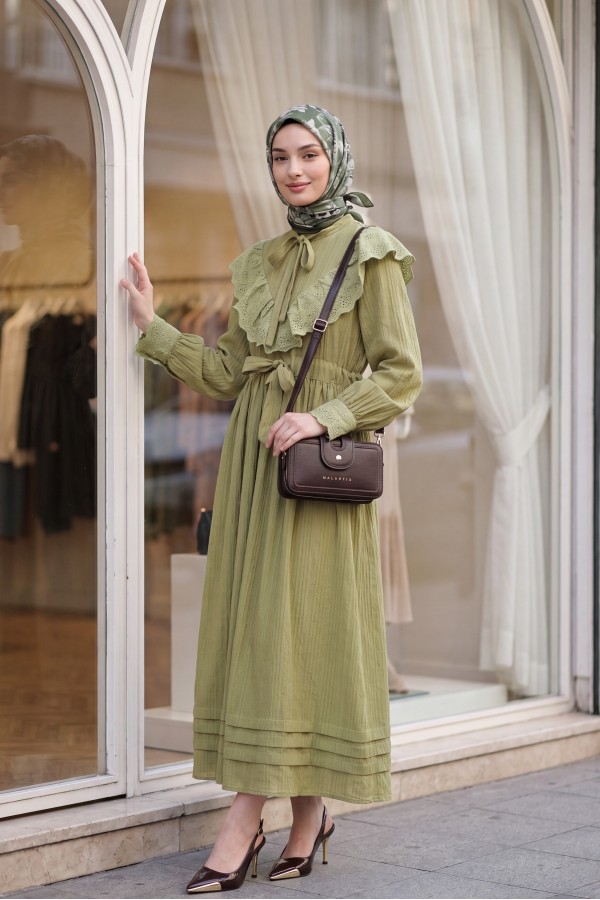 Lined crinkle dress with lace detailing at the neckline and waist. -Oil Green