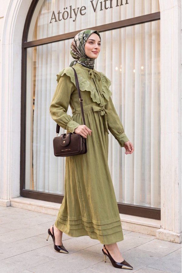 Lined crinkle dress with lace detailing at the neckline and waist. -Oil Green