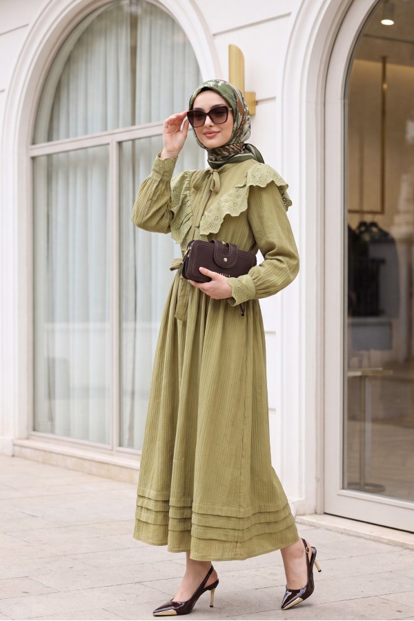 Lined crinkle dress with lace detailing at the neckline and waist. -Oil Green