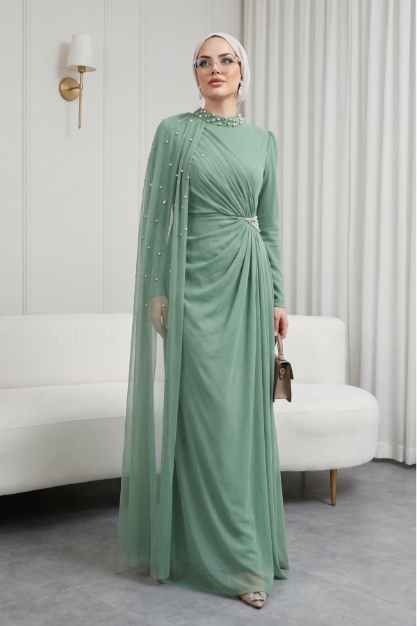High-neck evening gown with pearl detail and tulle cape. -Cagla Green