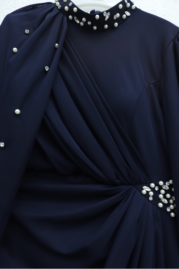 High-neck evening gown with pearl detail and tulle cape. -Navy blue