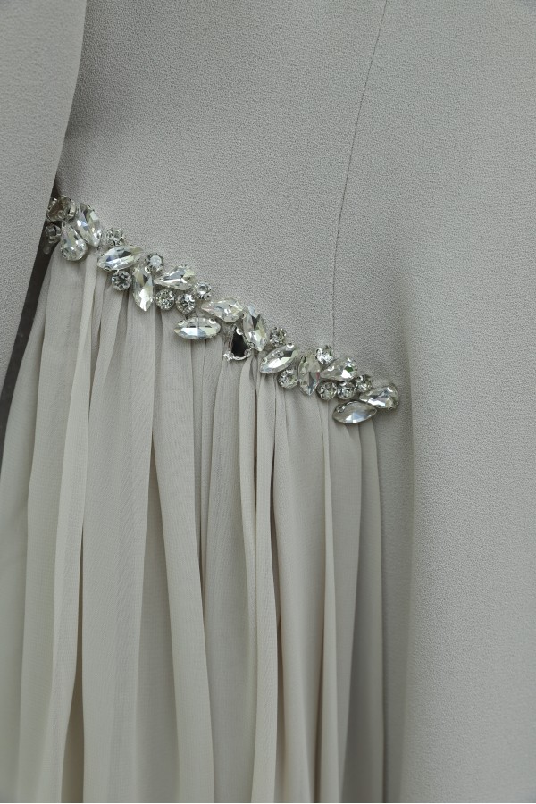 Crepe dress with rhinestone embellishments at the neckline and waist, and tulle details on the sides, now lined.   -Stone