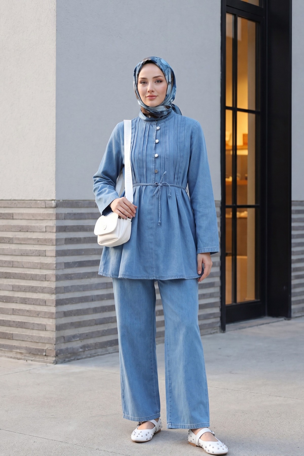 Half-buttoned, pleated front, tie-waist denim suit with trousers. -Light blue