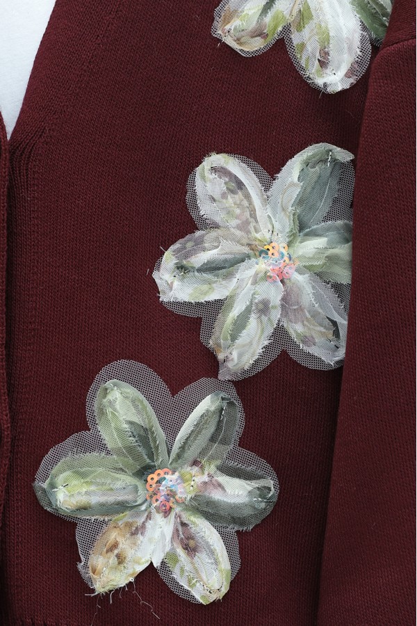 Buttoned knitted cardigan with sequin and floral details on the front. -Maroon