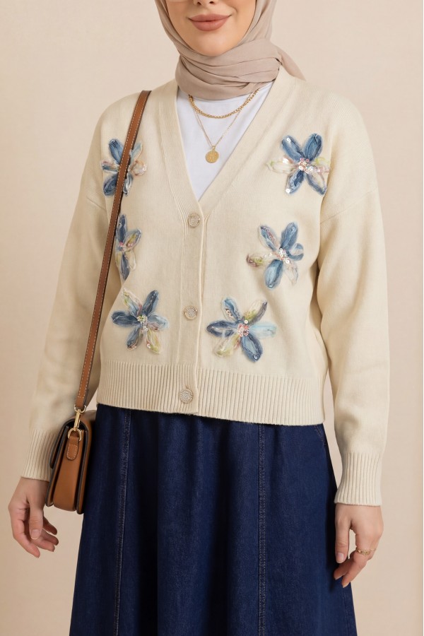 Buttoned knitted cardigan with sequin and floral details on the front. -Cream color