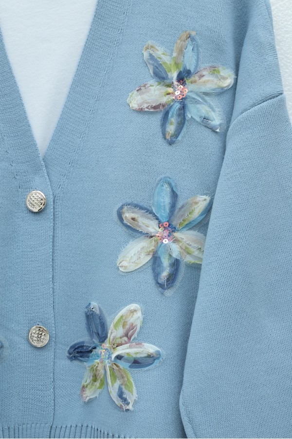 Buttoned knitted cardigan with sequin and floral details on the front. -Blue